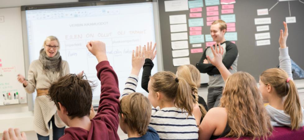 children raising hand at the classrom