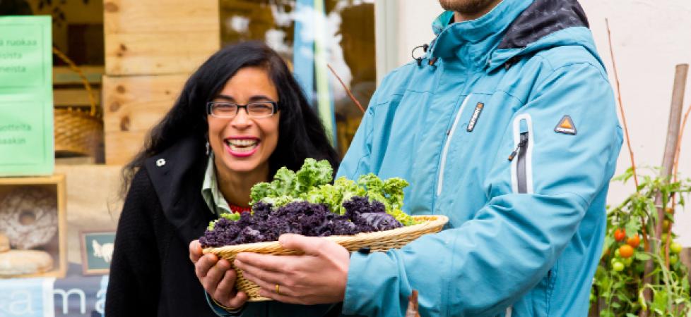 man and woman carrying harvest